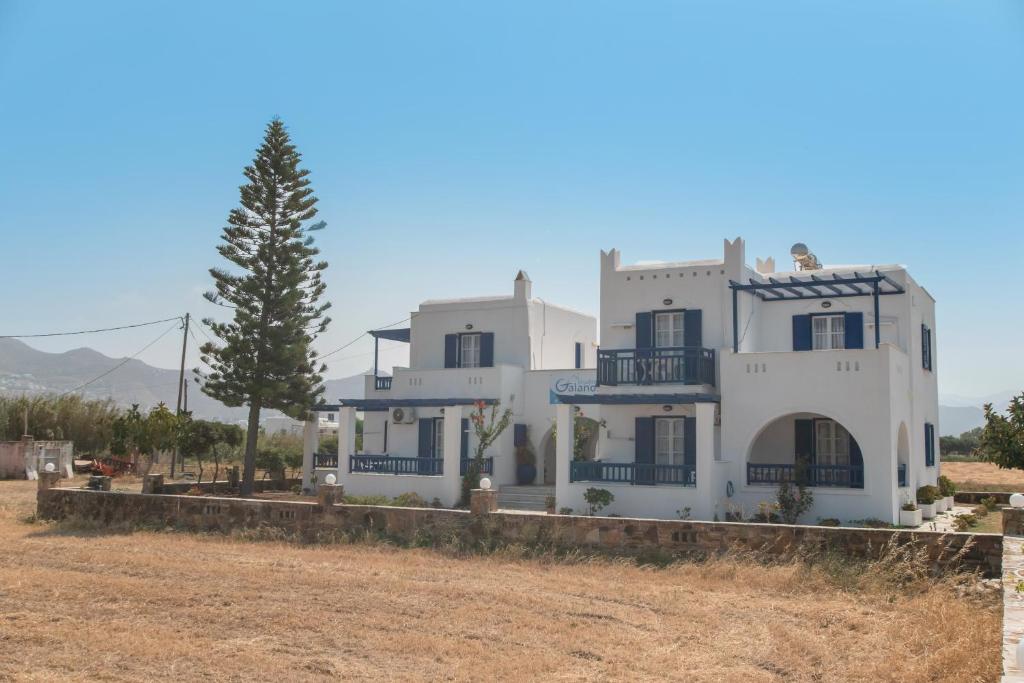 a large white house in the middle of a field at Galanos Studios Naxos in Naxos Chora