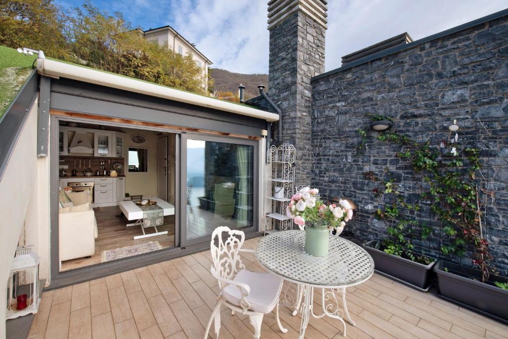 a patio with a table and chairs and a kitchen at Summer and Winter in Perledo