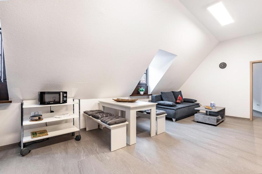 a living room with a couch and a table at Ferienwohnung Weitblick in Pottenstein