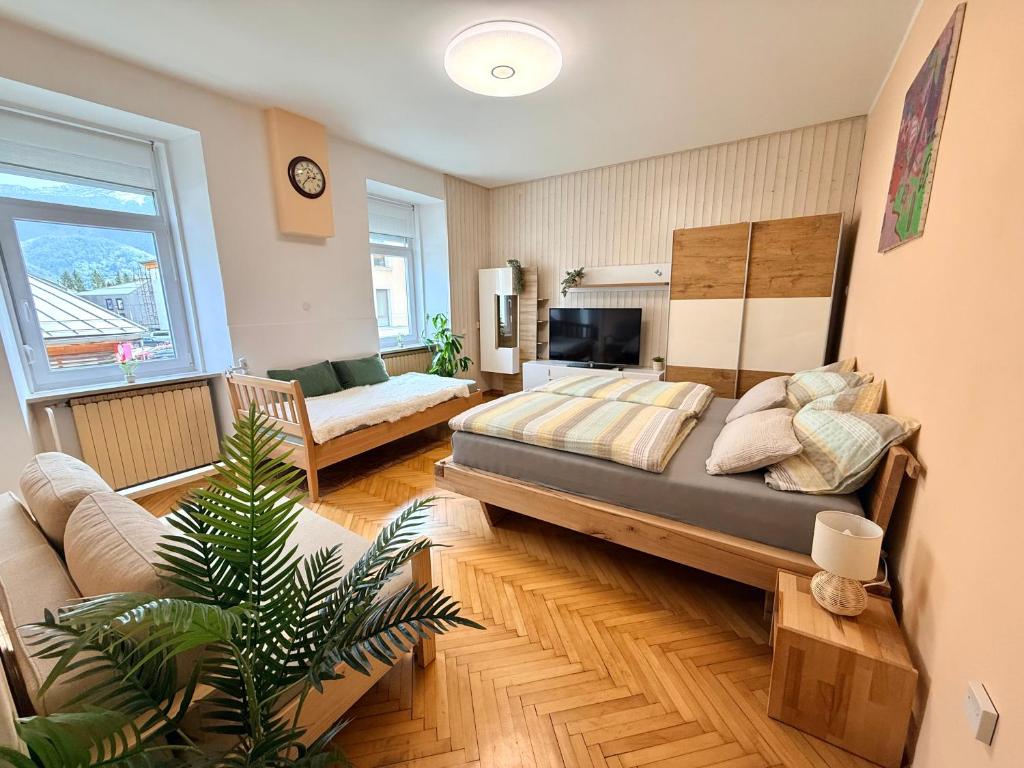 a bedroom with a bed and a living room at EDI APP Bovec Center-Free Parking & Mountain View in Bovec