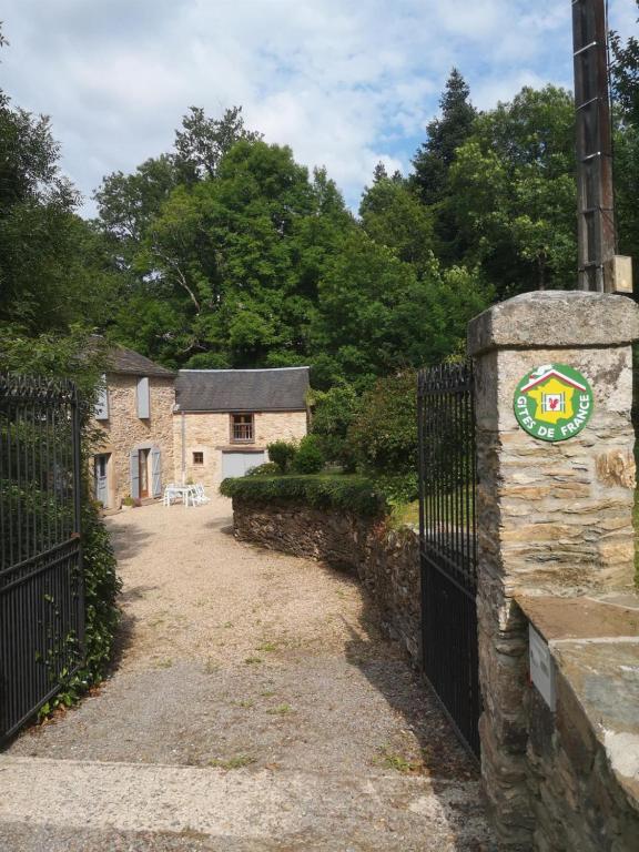 a gate to a house with a farm sign on it at Presbytère st michel de léon in Lacaze