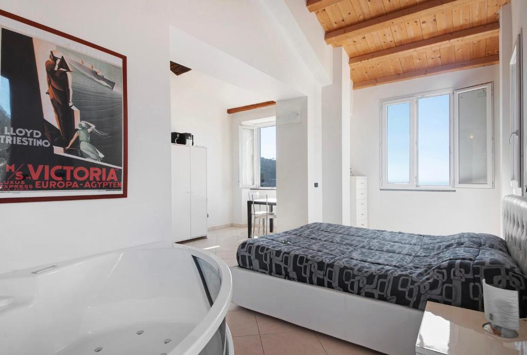 a white room with a bed and a glass table at Serra Monolocale in Bonassola