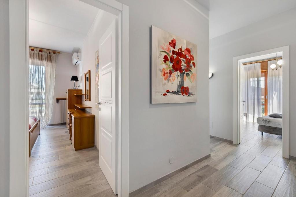 a living room with white walls and a painting on the wall at Giaely in Borghetto Santo Spirito
