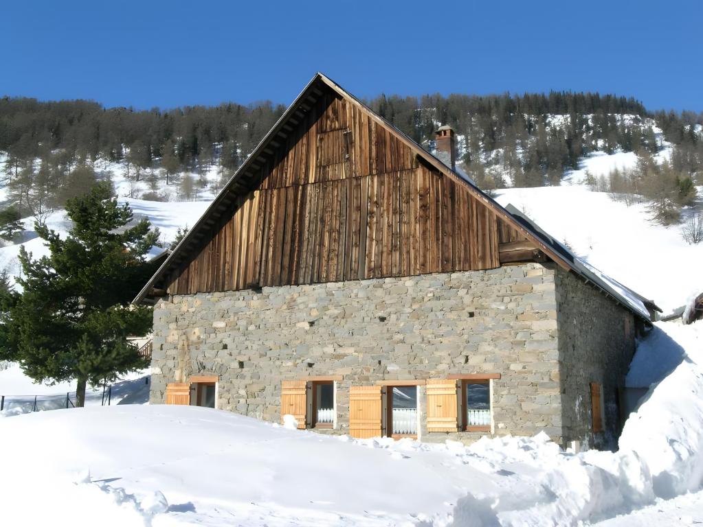 a stone barn in the snow at Chalet Blanchon in Montricher-Albanne