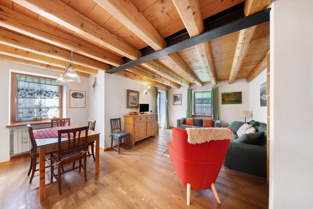 a living room with a table and a couch at Villa Cleila Verde B in San Vito di Cadore