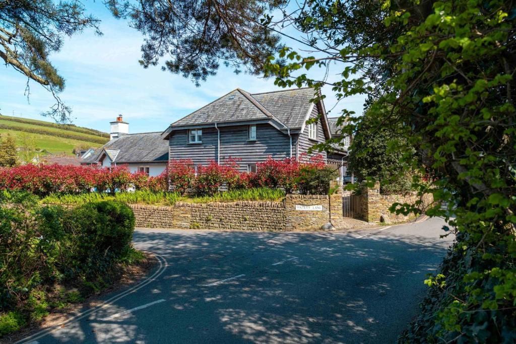 a house on a street with a driveway at Surfers Roost in Croyde