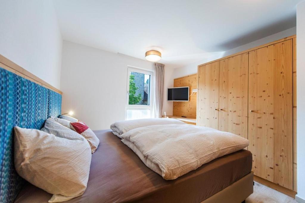 a bedroom with a large bed with a wooden headboard at Gass Apartment B in Laion