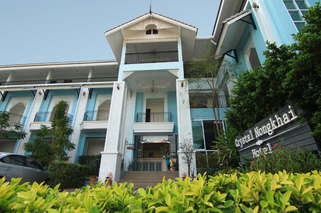 a building with a staircase in front of it at Crystal Nongkhai Hotel in Nong Khai