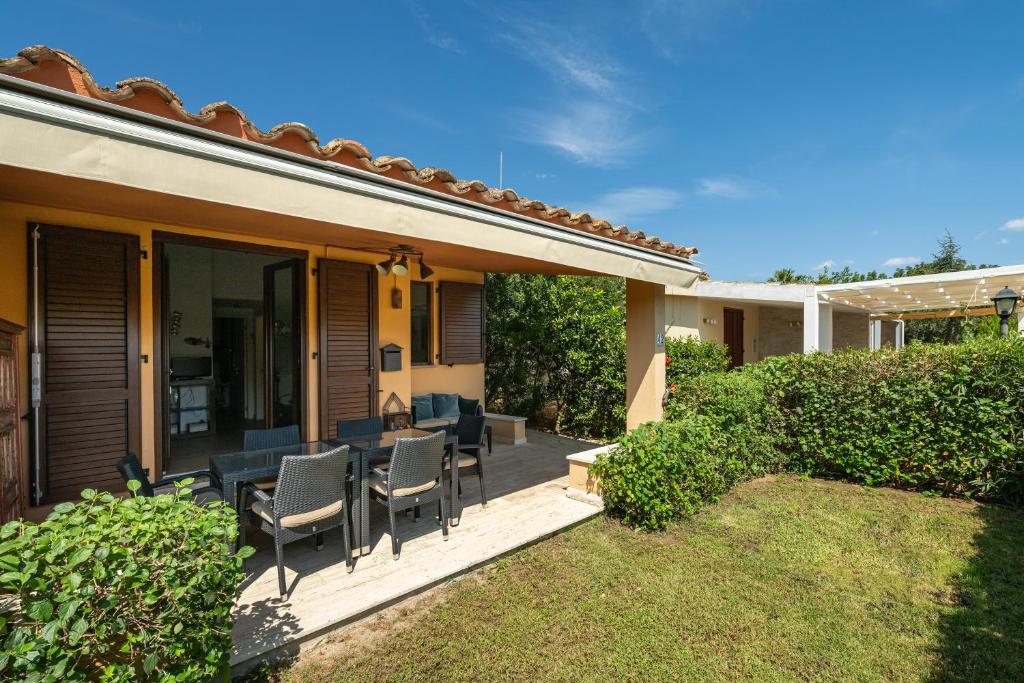 a patio with chairs and a table on a house at Casa Cò in Costa Rei