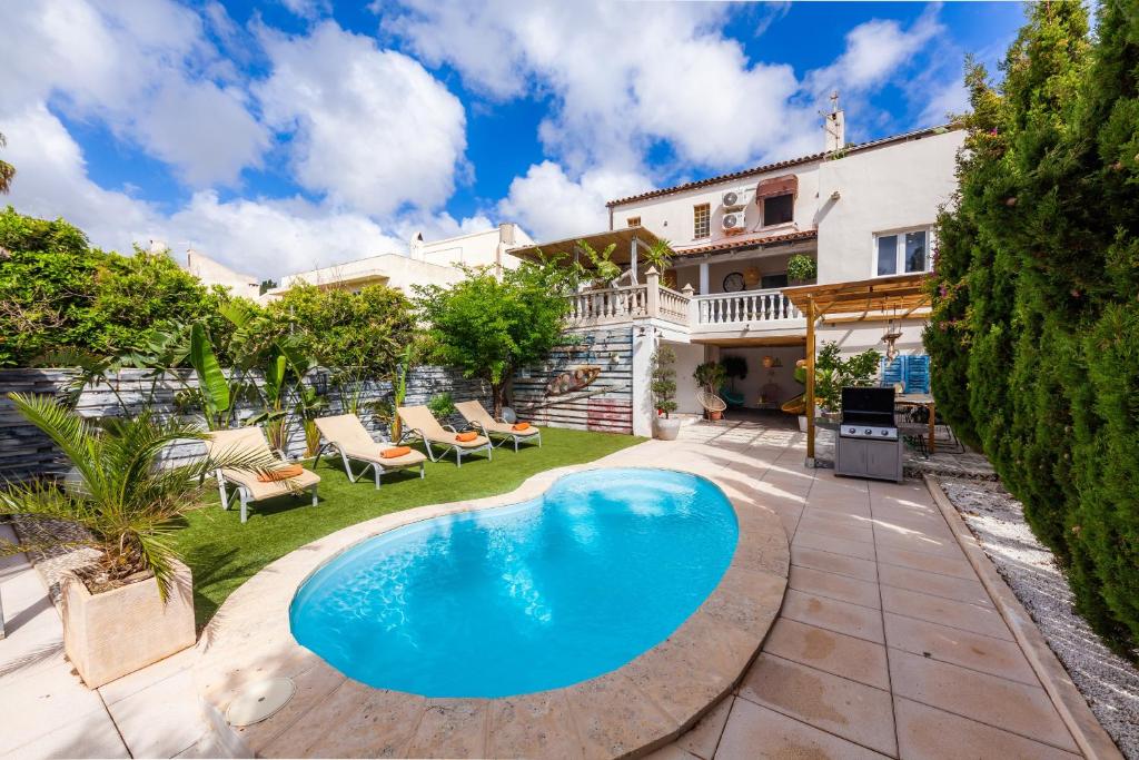 a swimming pool in the yard of a house at Casa Varna in Capdepera