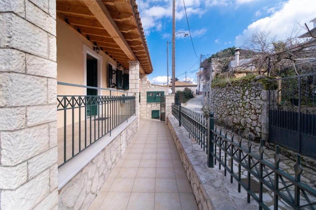 a walkway in a town with a stone wall at Villa Votistis A2 in Lefkada