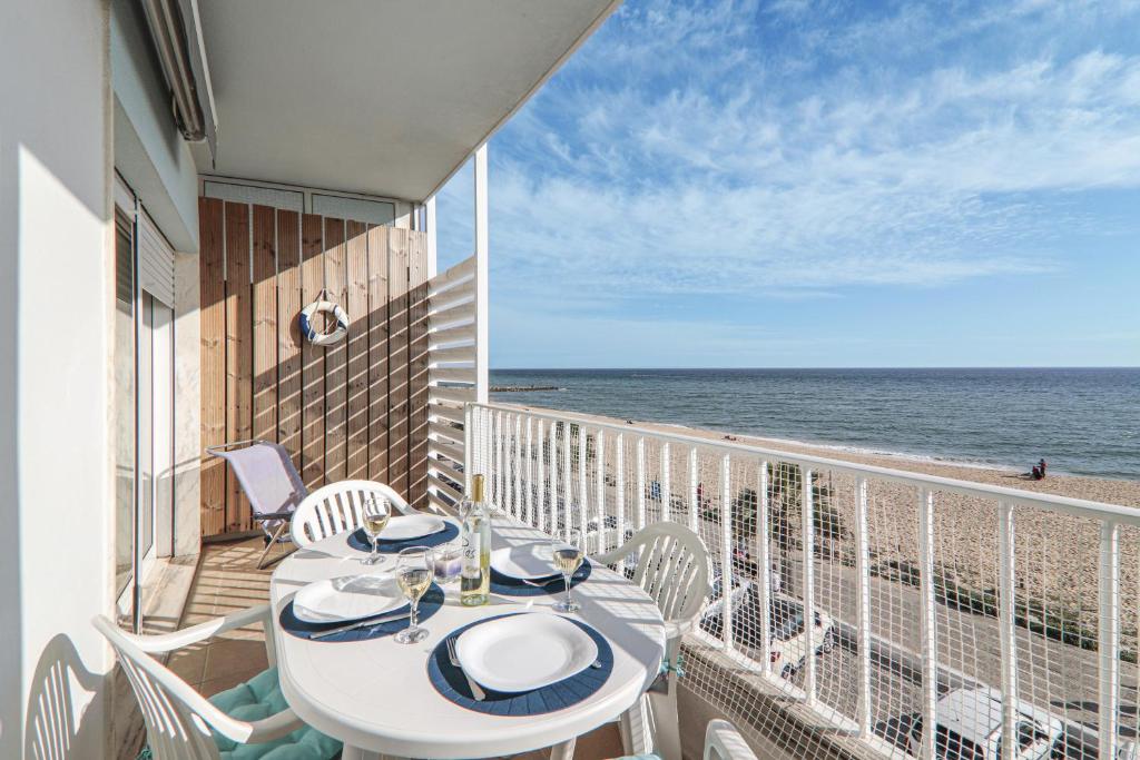 a balcony with a table and chairs and the ocean at Sail Away in Quarteira