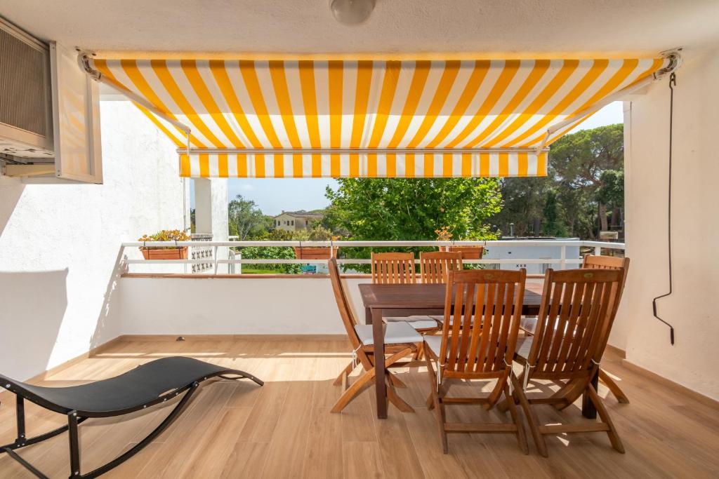 a dining room with a table and chairs on a balcony at Brava Beach in Platja d'Aro