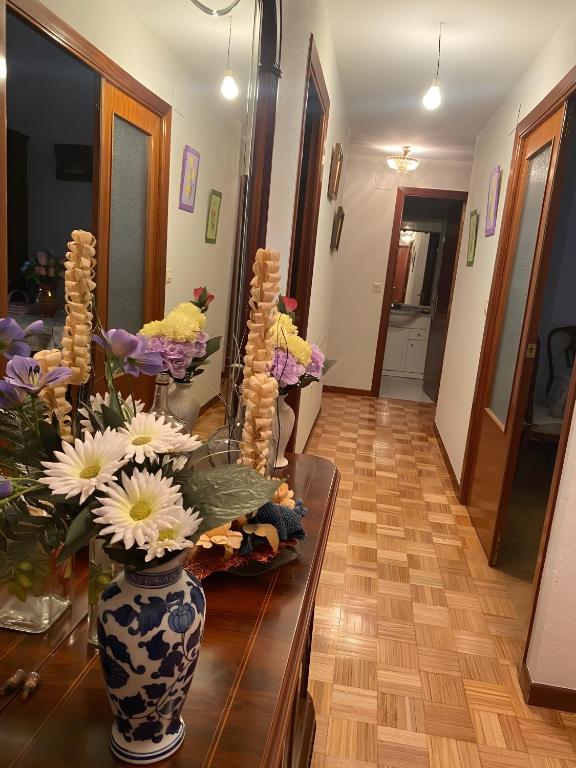 a room with a table with vases and flowers on it at Montes de Alhama Il in Soria