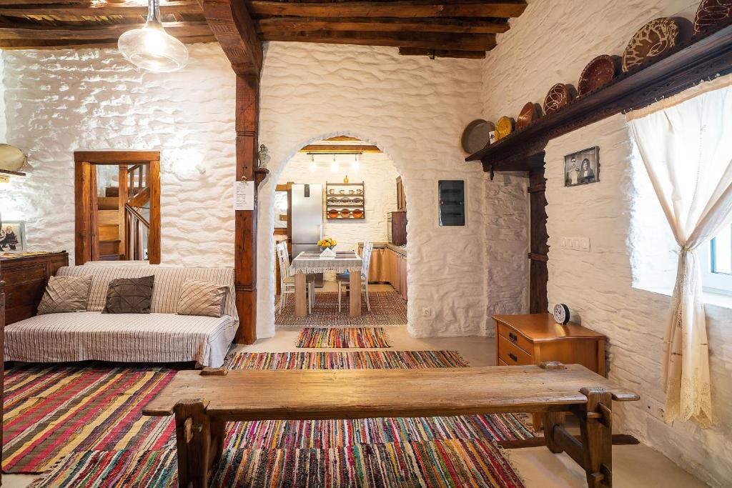 a living room with a couch and a table at Mannas House in Émbonas