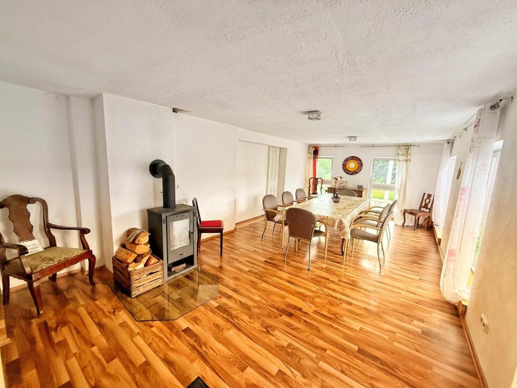 a living room with a table and a wood stove at Wohnung 6 und 7 in Burghaslach