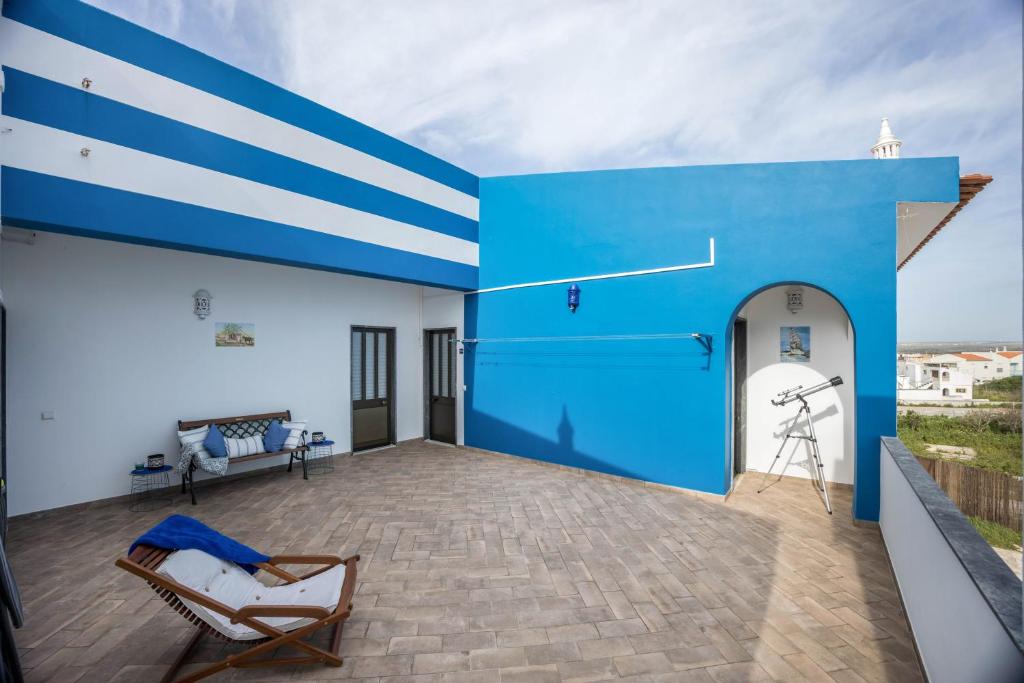 a blue and white house with a patio at Cabo de Sagres -2 bedroom apartment in Sagres