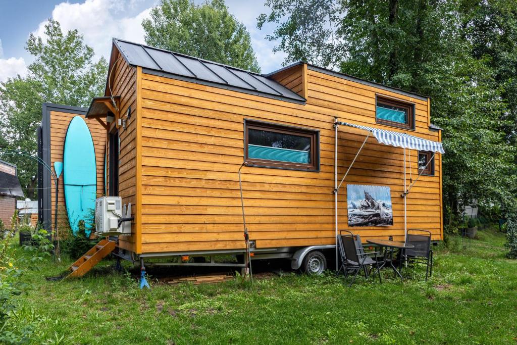 a tiny house on a truck in the grass at Tiny House Evita in Lehnin