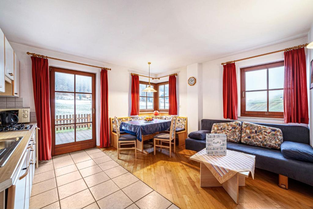 a living room with a couch and a table at Rieglhof Apartment Maisel in Curon Venosta