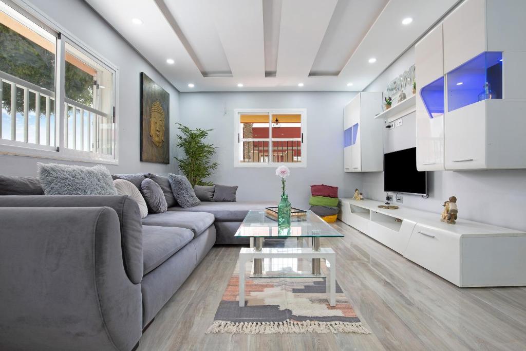 a living room with a couch and a table at Apartamento 7 dioses in Puerto del Rosario