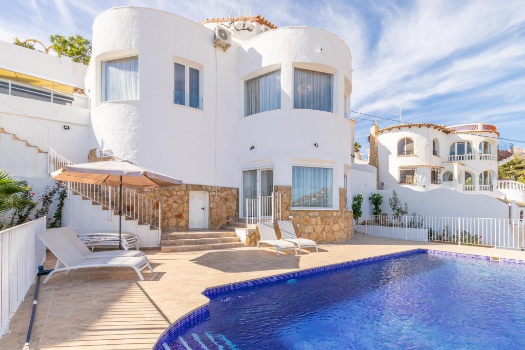 a villa with a swimming pool and a house at Villa Sol y Mar in Calpe