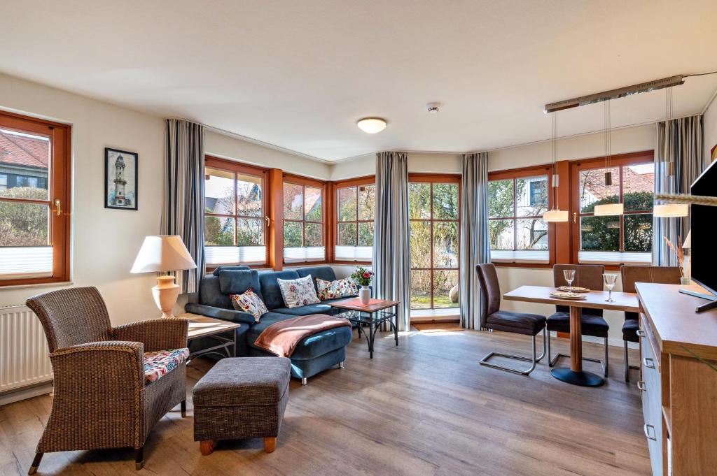 a living room with a couch and a table at Oewern Diek in Wustrow