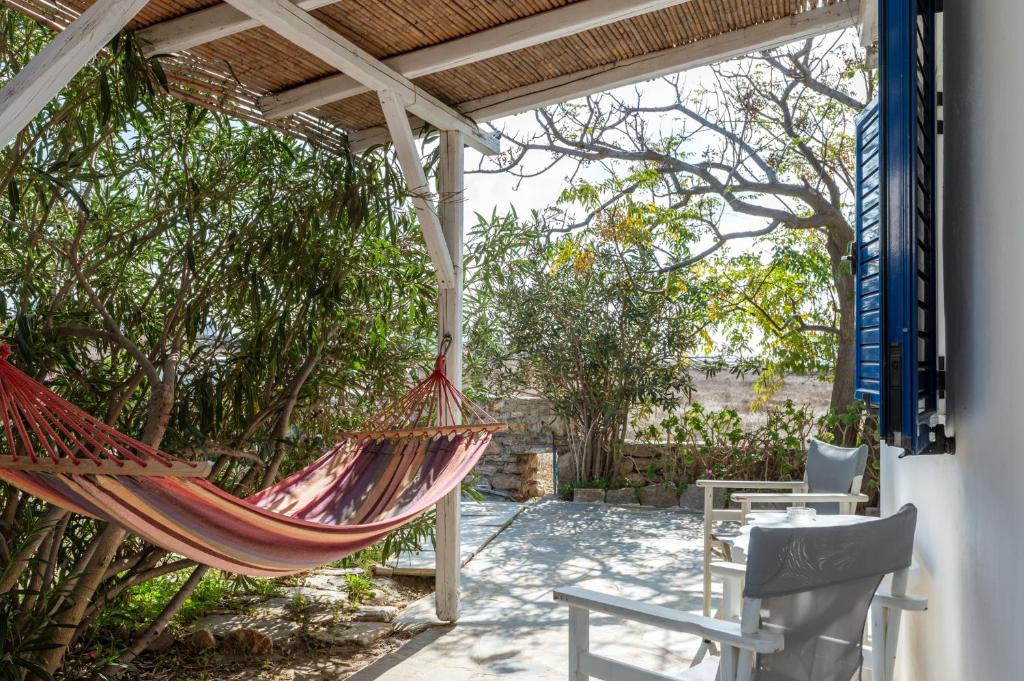 a hammock on the patio of a house at Margaret House in Parikia