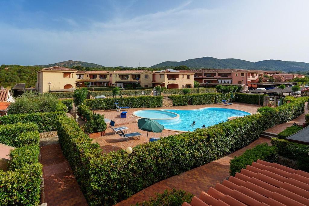 a resort with a swimming pool and some bushes at Casa Vacanze Pistacchio in Murta Maria
