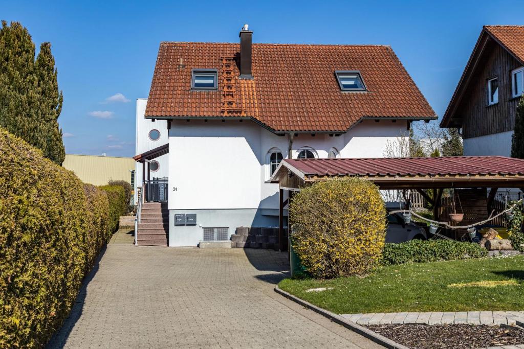 a white house with a red roof at Ülger in Pfullendorf