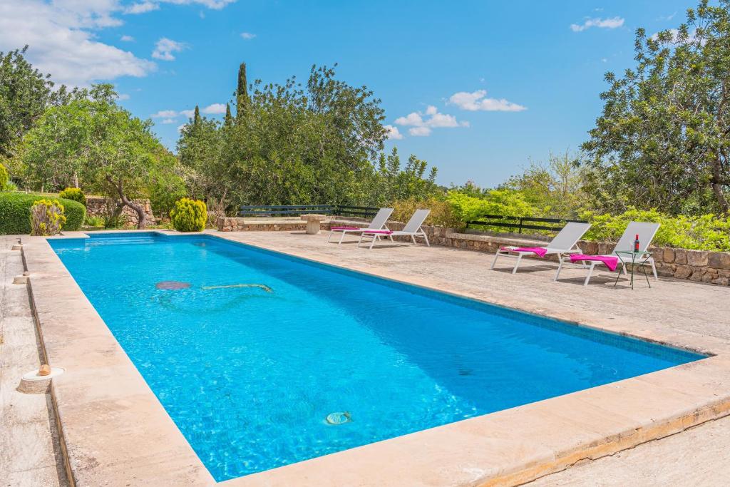 a swimming pool with lounge chairs and a swimming pool at Ca Nostra de Esporlas in Esporlas