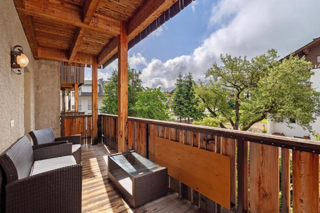 a balcony with chairs and a table on a deck at Kriendl Nr 2 in Valdaora