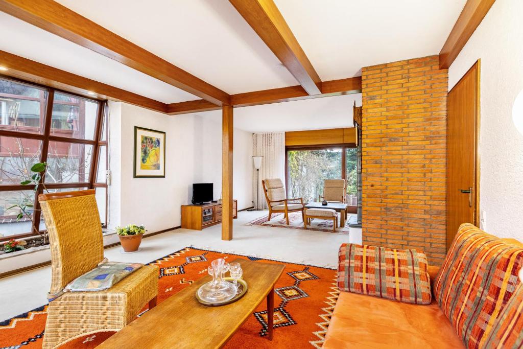 a living room with a couch and a table at Ferienhaus Hebborn in Bergisch Gladbach