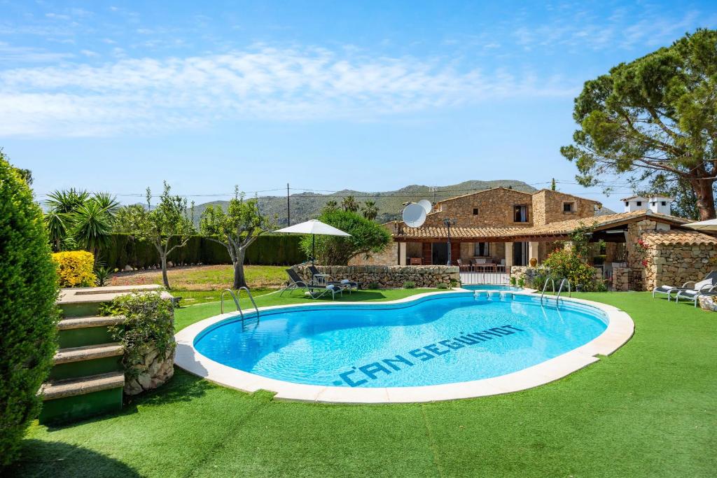 a swimming pool in the yard of a house at La Fortaleza in Pollença