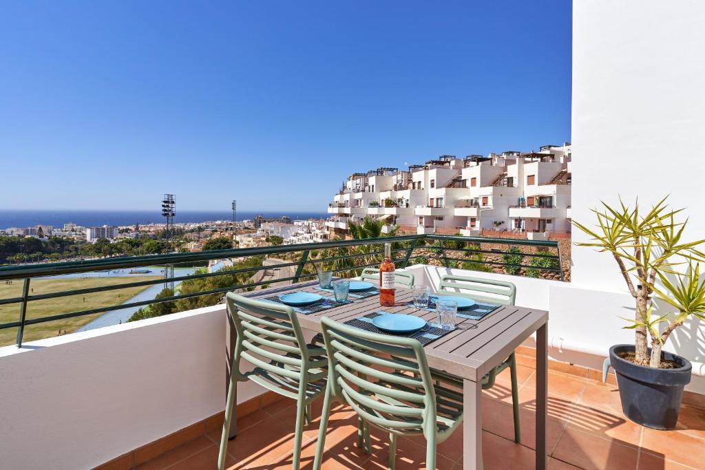 a table and chairs on a balcony with a view at 2-bedroom apartment with seaview in Nerja