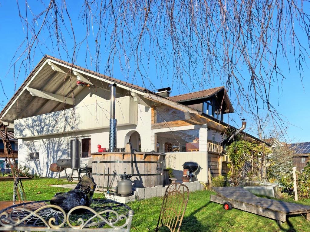 a house with awning on the front of it at Haus Blaulichtfamilie in Opfenbach