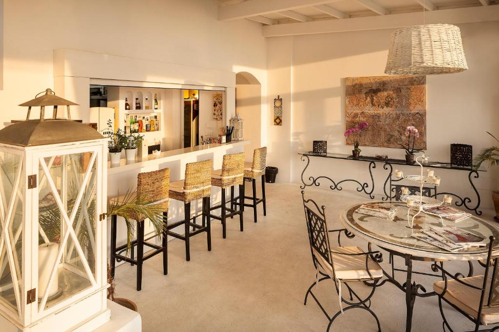 a room with a bar with chairs and a table at Tenuta Del Poggio Antico in Ischia