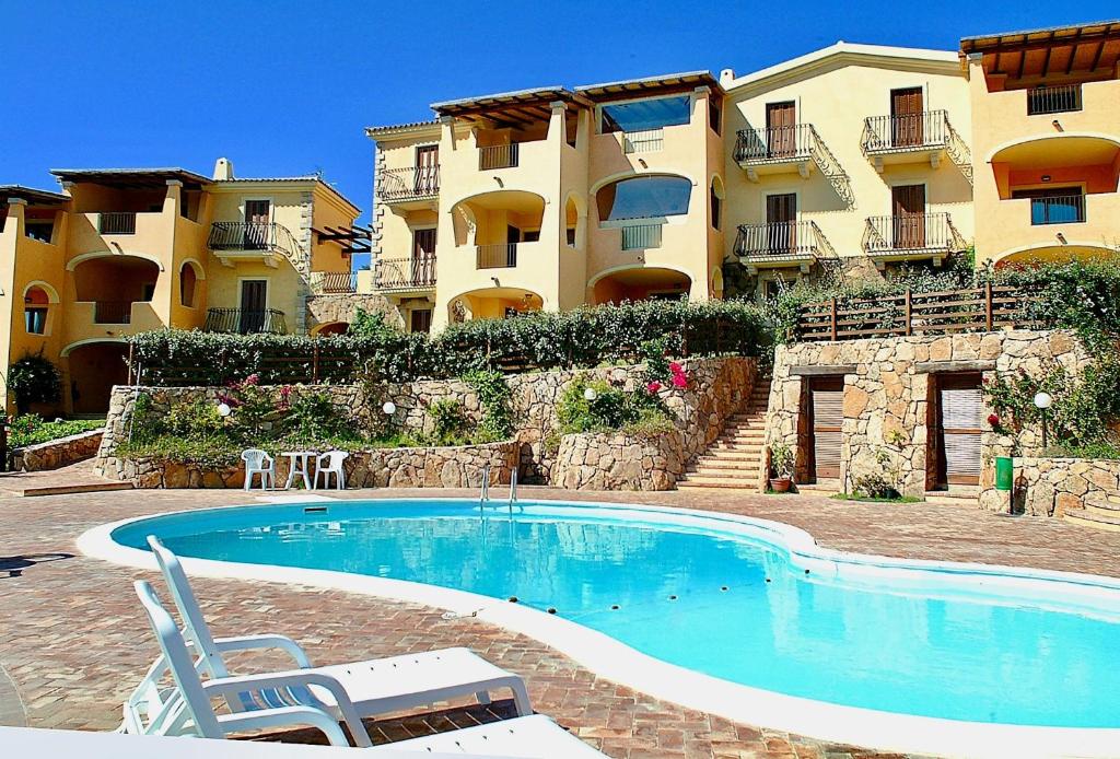a swimming pool in front of a building at Bia de Bados B5 in Olbia