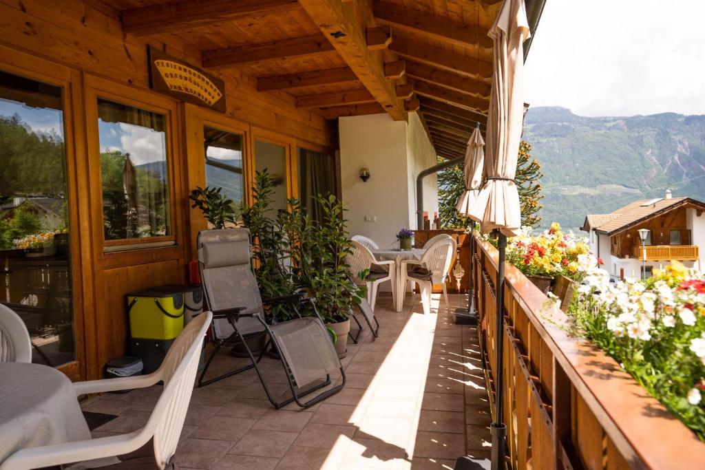 a balcony of a restaurant with tables and chairs at Apartment Ida - Obermösslhof in Lana