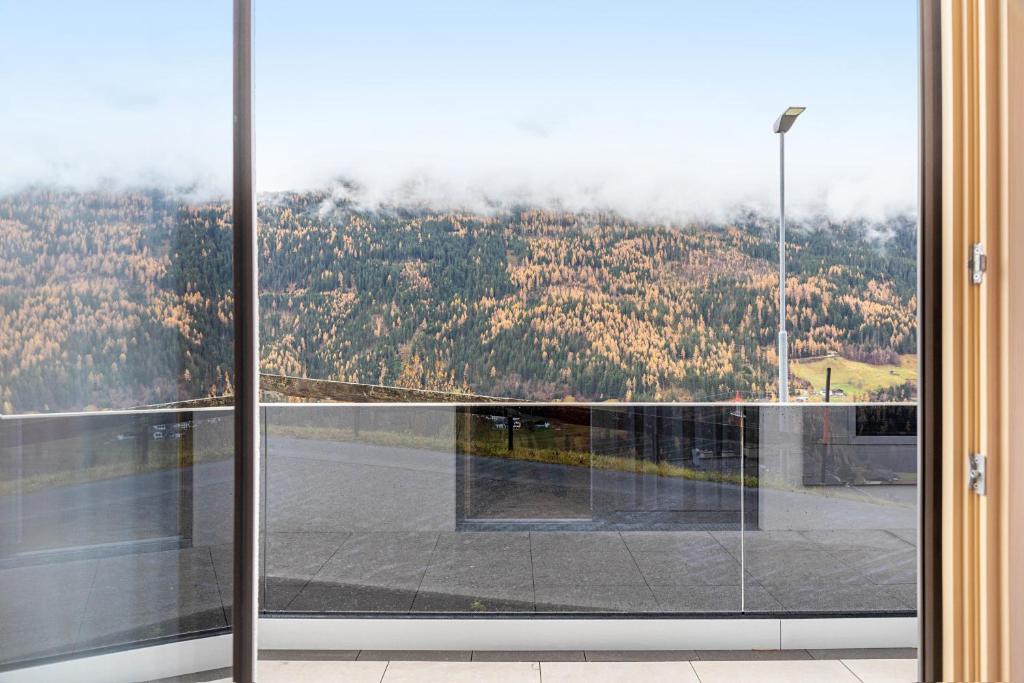an open glass door with a view of a mountain at Ferienwohnung Elsa in Fliess