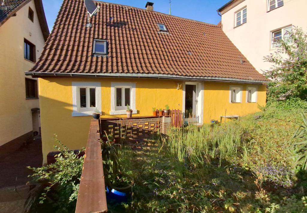 a yellow house with a brown roof at Charming House in Neckargemünd