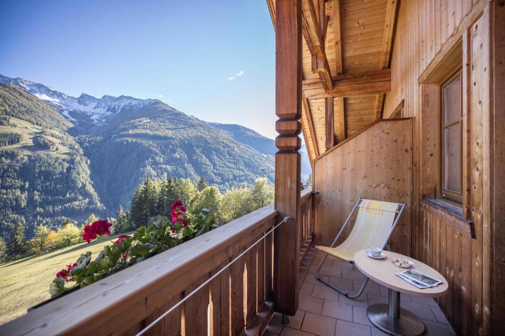a balcony with a table and a view of mountains at Kuglerhof Apt 2 in Cadipietra