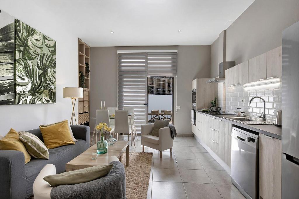a kitchen and living room with a couch and a table at Urban Park Aloe in Los Llanos de Aridane