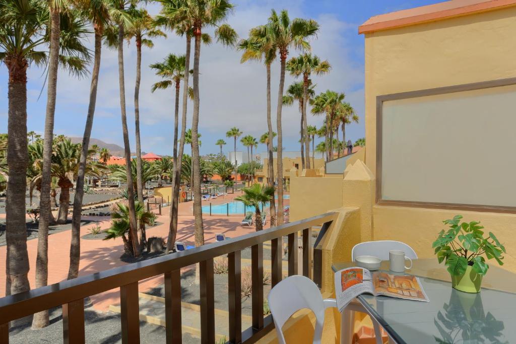 a view from the balcony of a resort with palm trees at Oasis Royal F306 in Corralejo