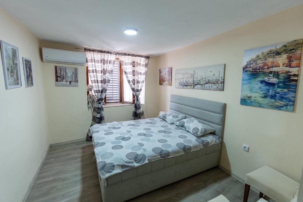 a small bedroom with a bed and a window at Old street 2 in Podgorica