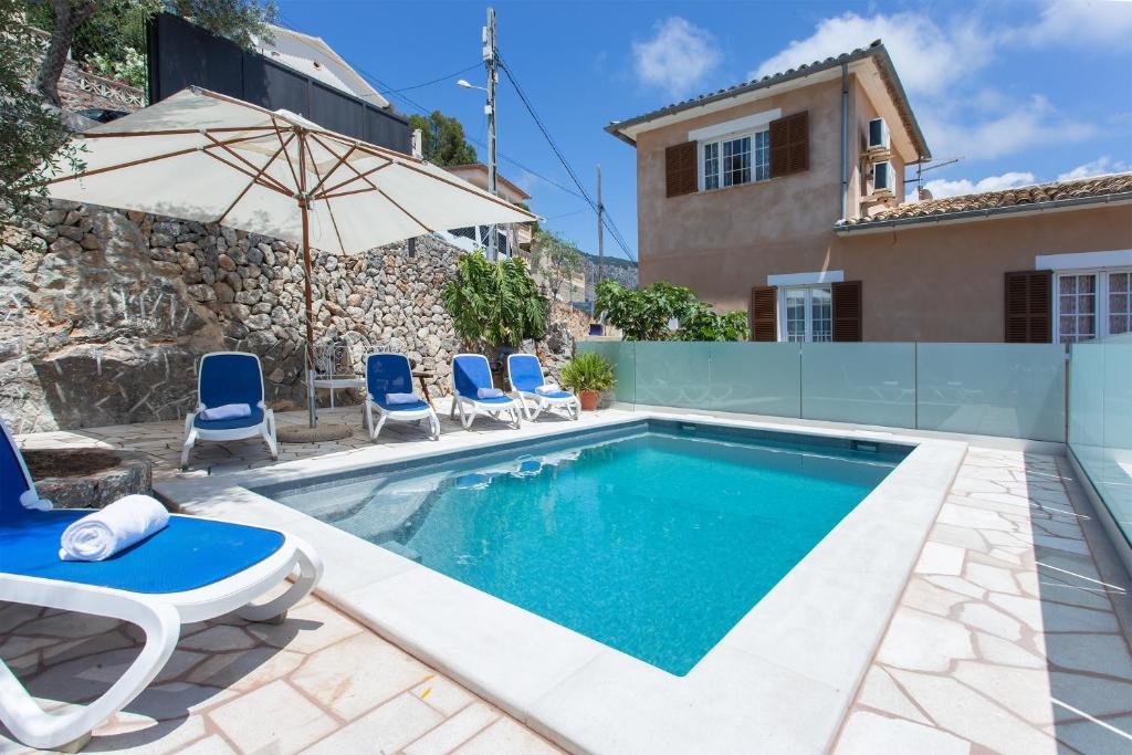a villa with a swimming pool and a house at Casa Paqui in Port de Soller