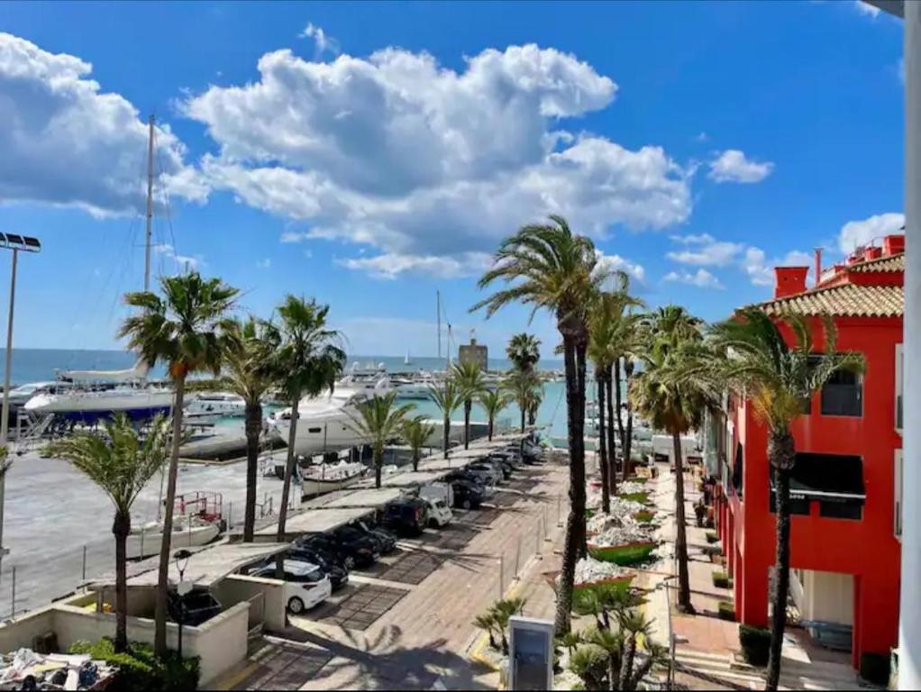 a street with palm trees and a marina at Apartamento Puerto Sotogrande in Sotogrande