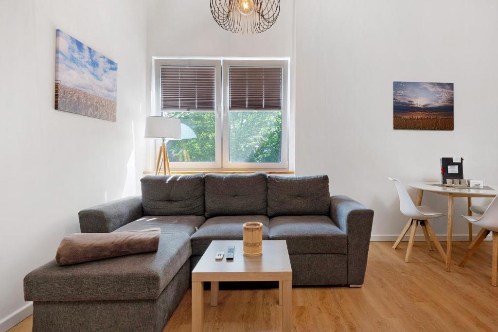 a living room with a couch and a table at Ferienwohnung Junge 1 in Lohe-Rickelshof