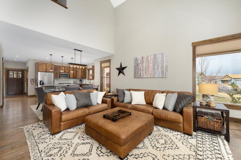 a living room with two couches and a kitchen at 74 Alder Brook in Fraser