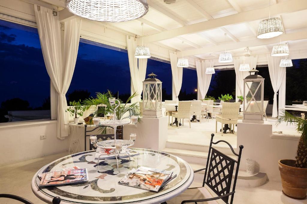a dining room with a glass table and chairs at Tenuta Del Poggio Antico in Ischia