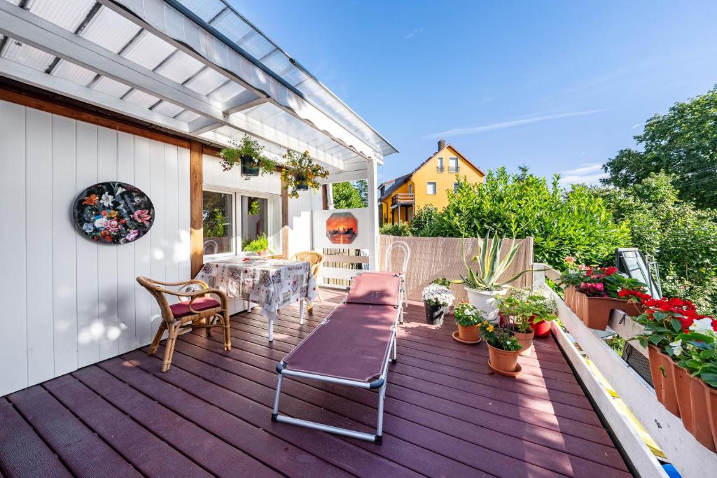 a patio with a table and chairs on a deck at Fewo mit Terrasse Moritzburg in Moritzburg
